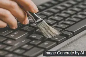 A Person cleaning a computer keyboard with a small brush